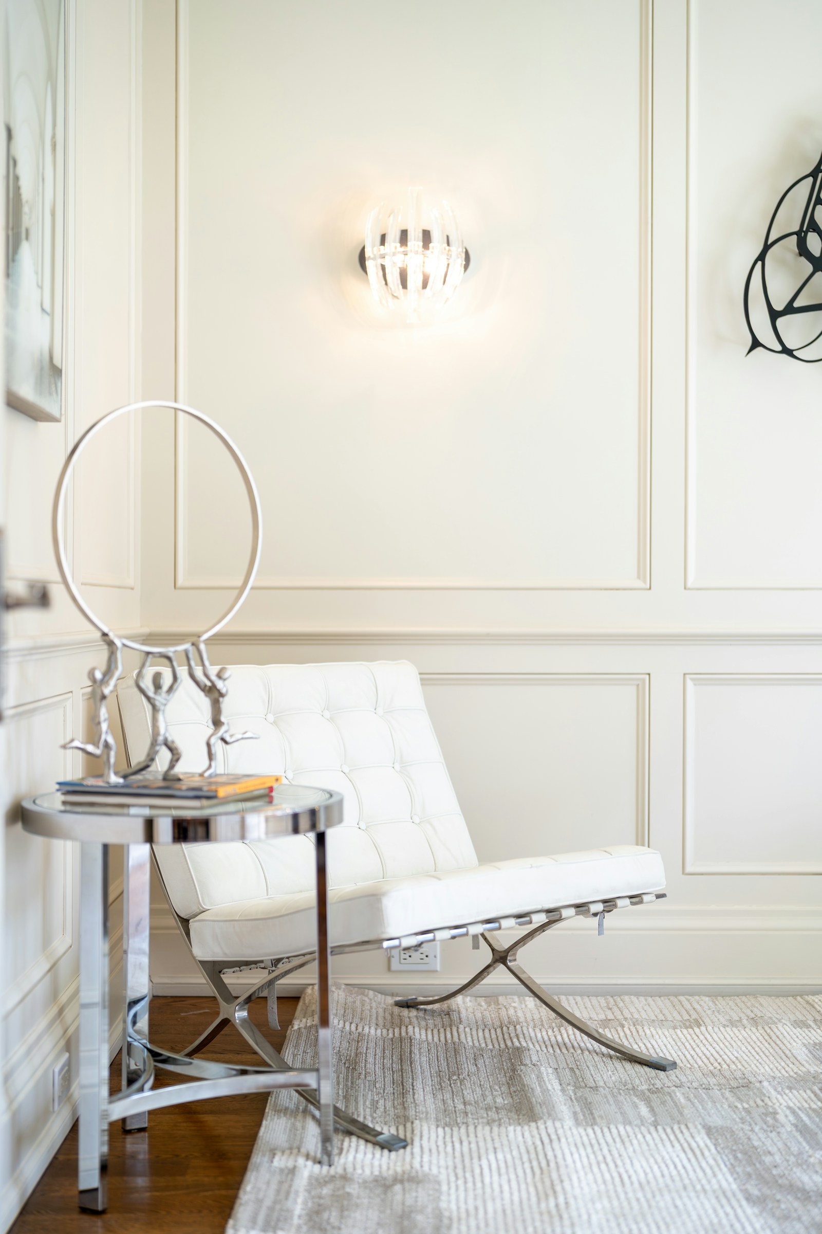 Modern accent armchair with light upholstery in a styled room