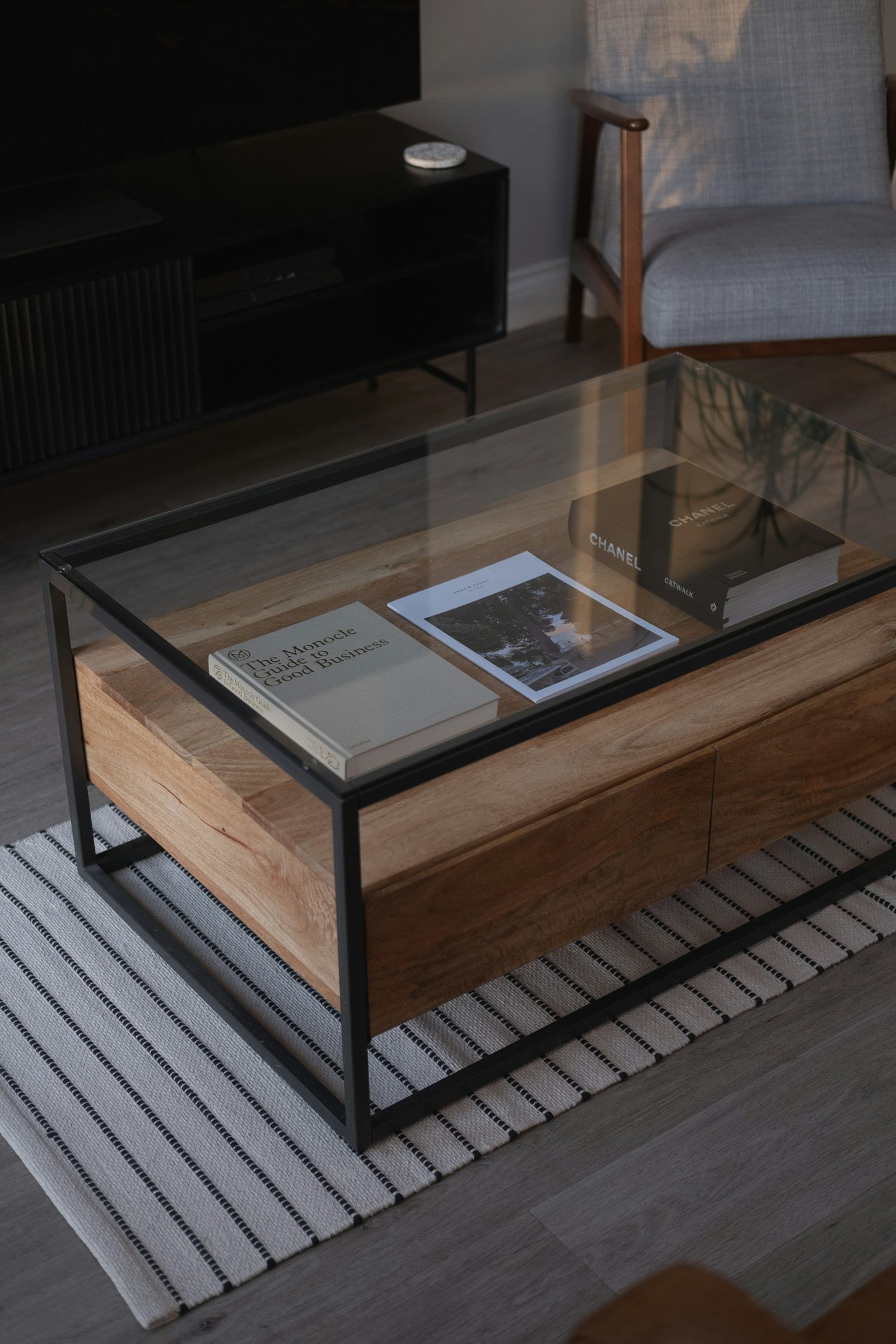 Round coffee table styled with books in a living room